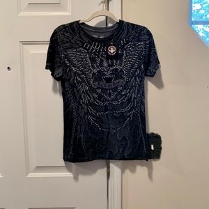 New shirt with tags. Lots of feather designs, shiny grommets front & back.